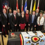 Presidents stand behind a table after signing the Indigenous Education Blueprint