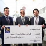 Edward Acuna presents a donation of $1,000 to the Asper School of Business