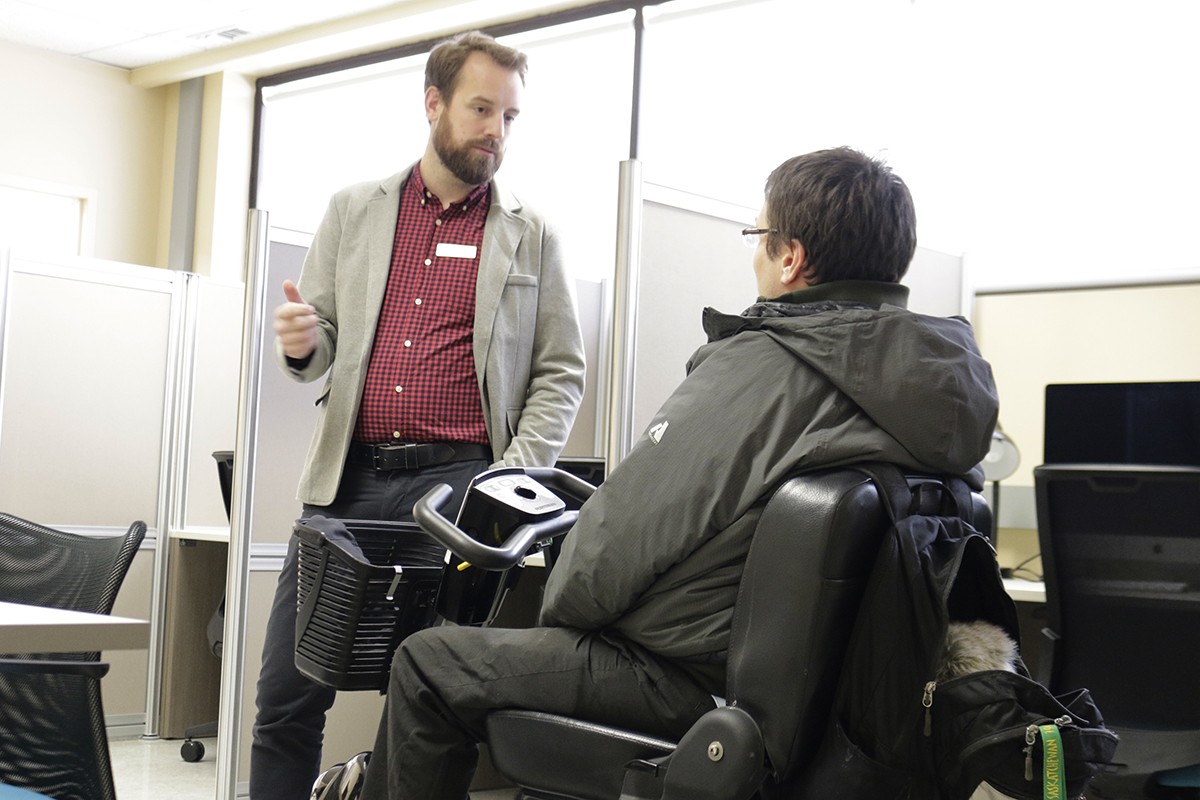 Assistive Technologist Jeff Buhse, speaking with a student in the new Assistive Technology Lab
