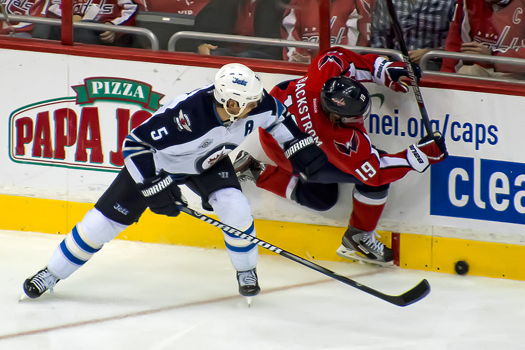 Winnipeg Jets defenseman Mark Stuart checks Washington Capitals forward Nicklas Backstrom. // Photo: clyde, Flickr