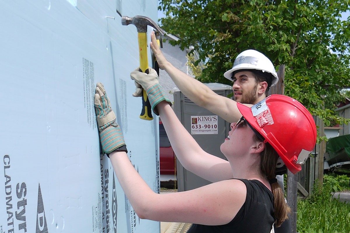 Volunteers work with Habitat for Humanity on the home. Photo from @UM_RadyFHS
