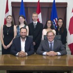 Signatories of the new Alberta education agreement (front l-r, Ry Moran, Director, National Centre for Truth and Reconciliation, University of Manitoba and Alberta Education, Minister David Eggen).