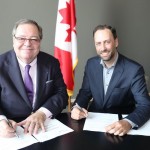 Guy Berthiaume (left) and Ry Moran formalizing their new agreement.