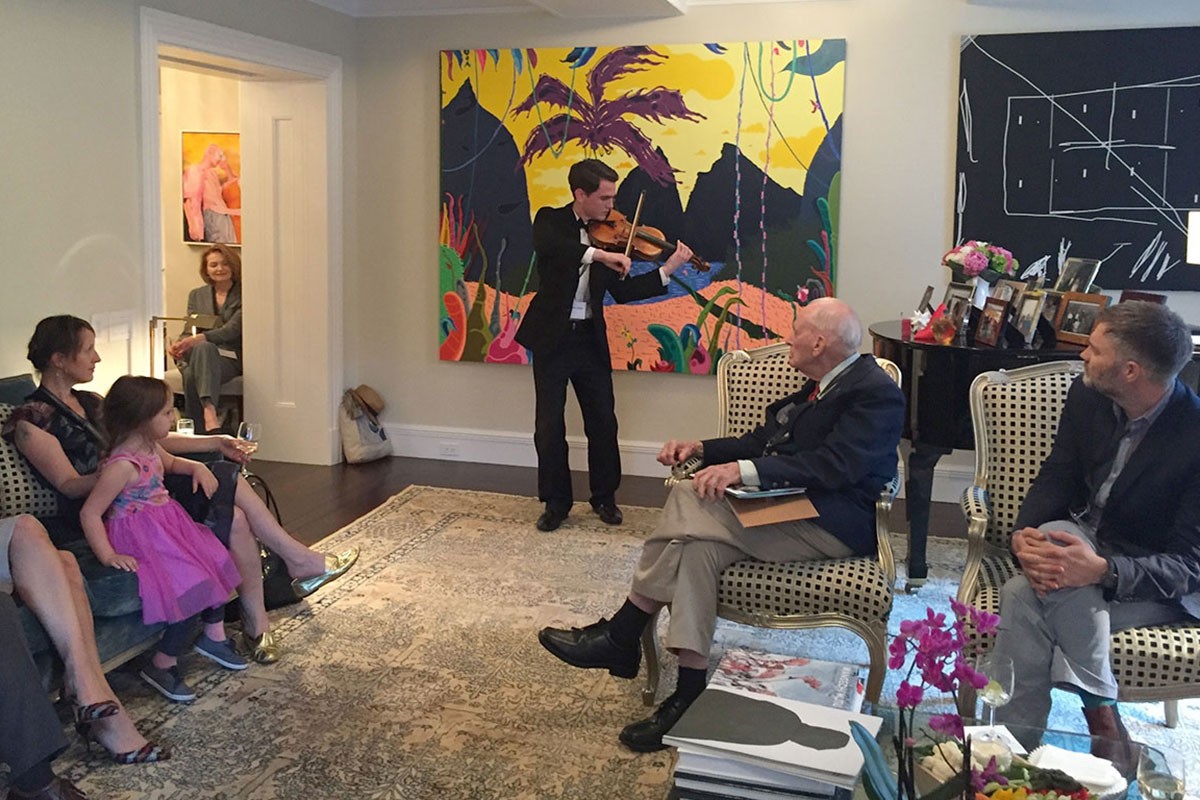 Alumni at the reception in New York on June 9, 2016 with Desautels Faculty of Music student Gregory Lewis playing violin.