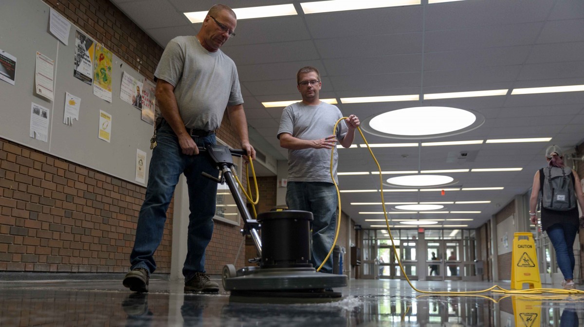 Floors in Fletcher Argue Building get a resurfacing treatment, one of many summer deep clean and repair projects undertaken by caretakers this summer. Pictured here are caretakers Peter Kielich and Ian Kemball. // Photos by Adam Dolman
