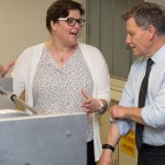 (L-R) Chemistry professor Jennifer van Wijngaarden and MP Terry Duguid look over a magnetic resonance chamber in a chemistry lab on Aug. 22, 2016.