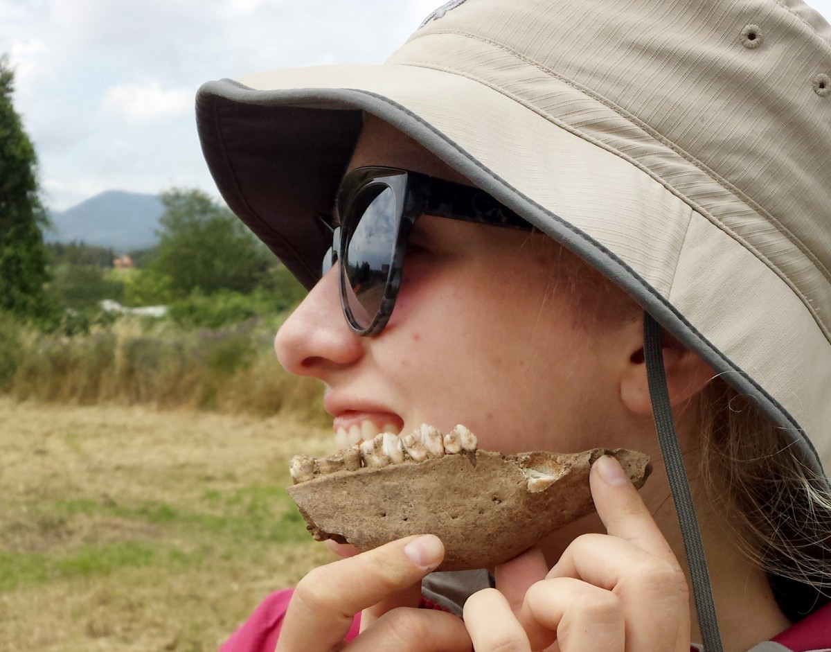 Amber Leenders, posing with an animals bone she excavated and cleaned at a dig in Caere, Italy