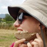 Amber Leenders, posing with an animals bone she excavated and cleaned at a dig in Caere, Italy