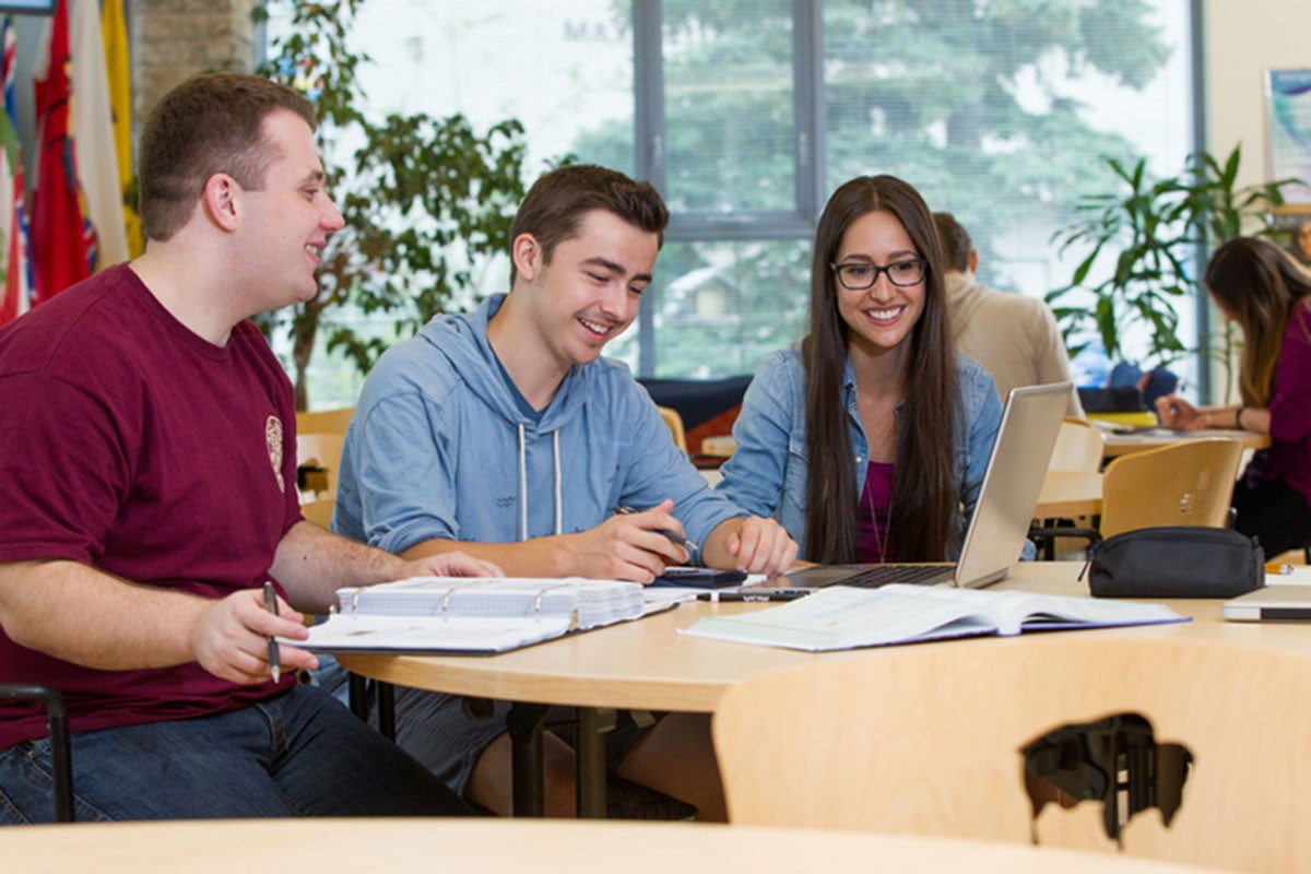 Students study inside Migizii Agamik - Bald Eagle Lodge.