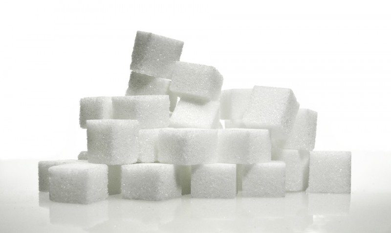 sugar cubes stacked and standing before a white background