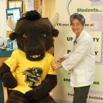 Billy the Bison knows that getting a flu shot from pharmacist Meera Thadani is the best way to ensure we all have 'herd immunity' on campus.