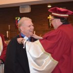Ronald F. Smith [BSc/66, BEd /71, PostBacEd/91) receives honorary membership in the St. Paul’s College Assembly.