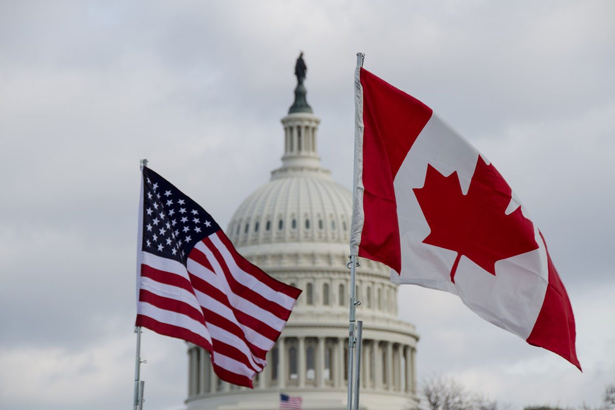 Canadian and U.S. flag image from Photo Phiend/Flickr.