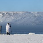 An Inuit hunters walks on sea ice