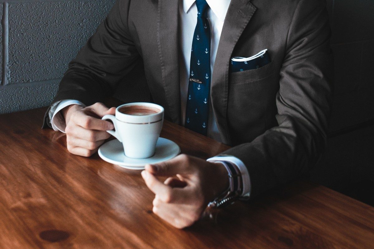 man in suit with coffee