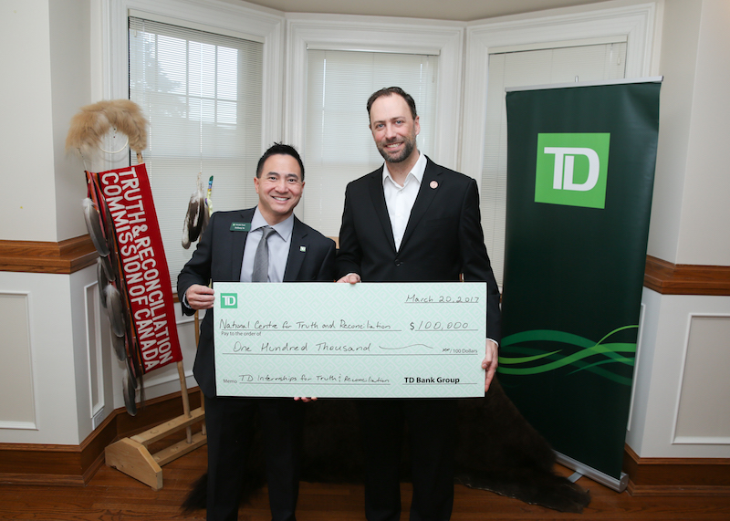 TD's Anthony Yu (left) presents a cheque to Ry Moran, director of NCTR