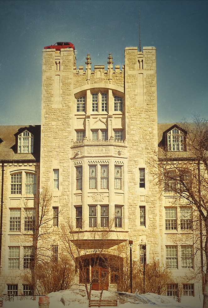 A car sits atop one of the towers of Tier building.