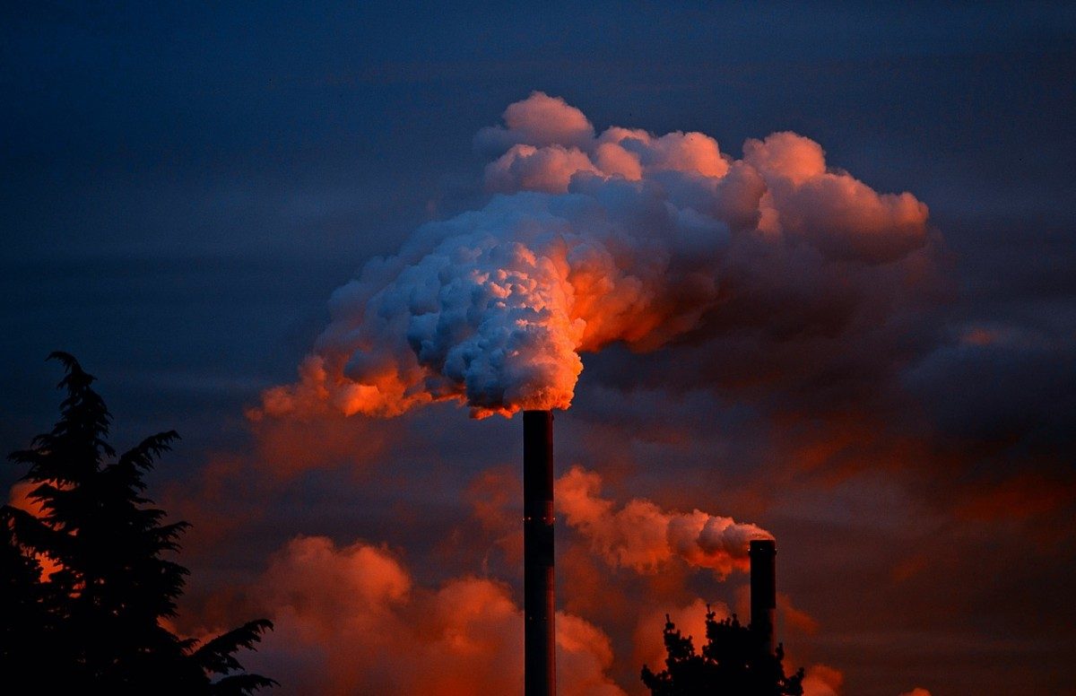 A smoke stack at sunset