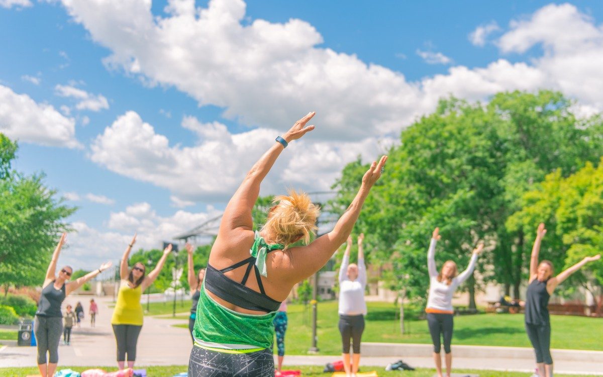 People practicing yoga outside