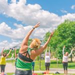 People practicing yoga outside