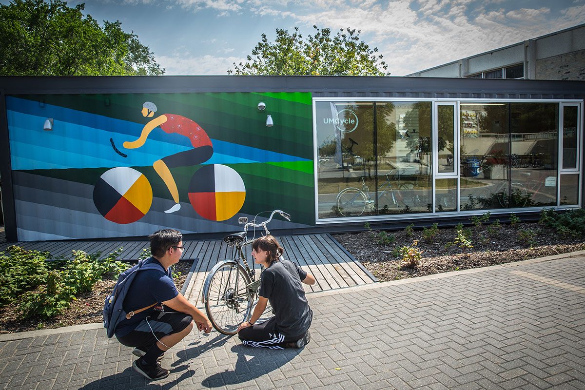 The UMCycle Bike Kiosk and Cycle Plaza features a mural from artists Dee Barsy and Kenneth Lavaliere.