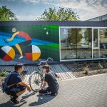 The UMCycle Bike Kiosk and Cycle Plaza features a mural from artists Dee Barsy and Kenneth Lavaliere.