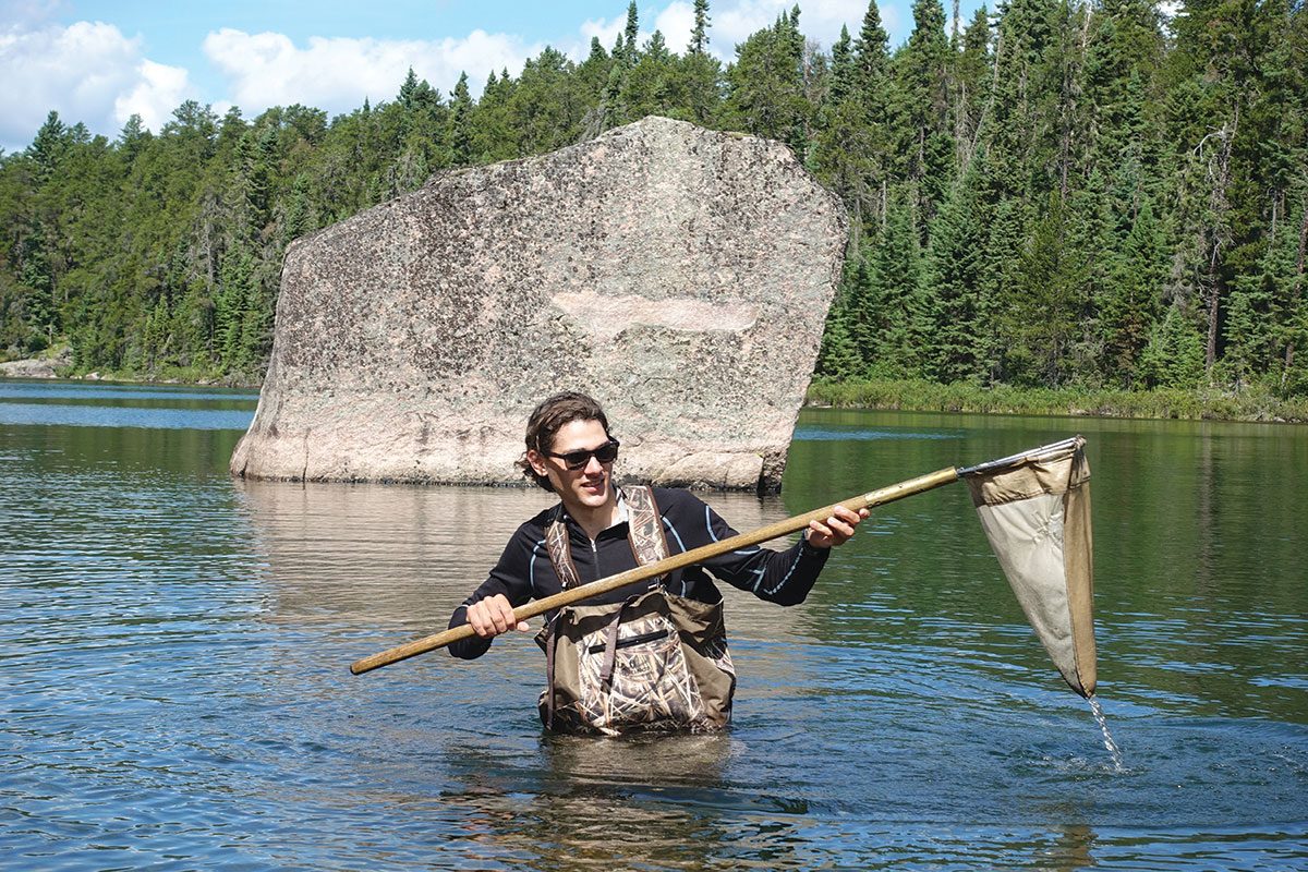 Justin Budyk kick-nets for dragonfly larva and other benthic invertebrates as part of a research project for his co-op program at the IISD-ELA. The insects were to be identified, used to determine isotopic signatures and included in a survey.