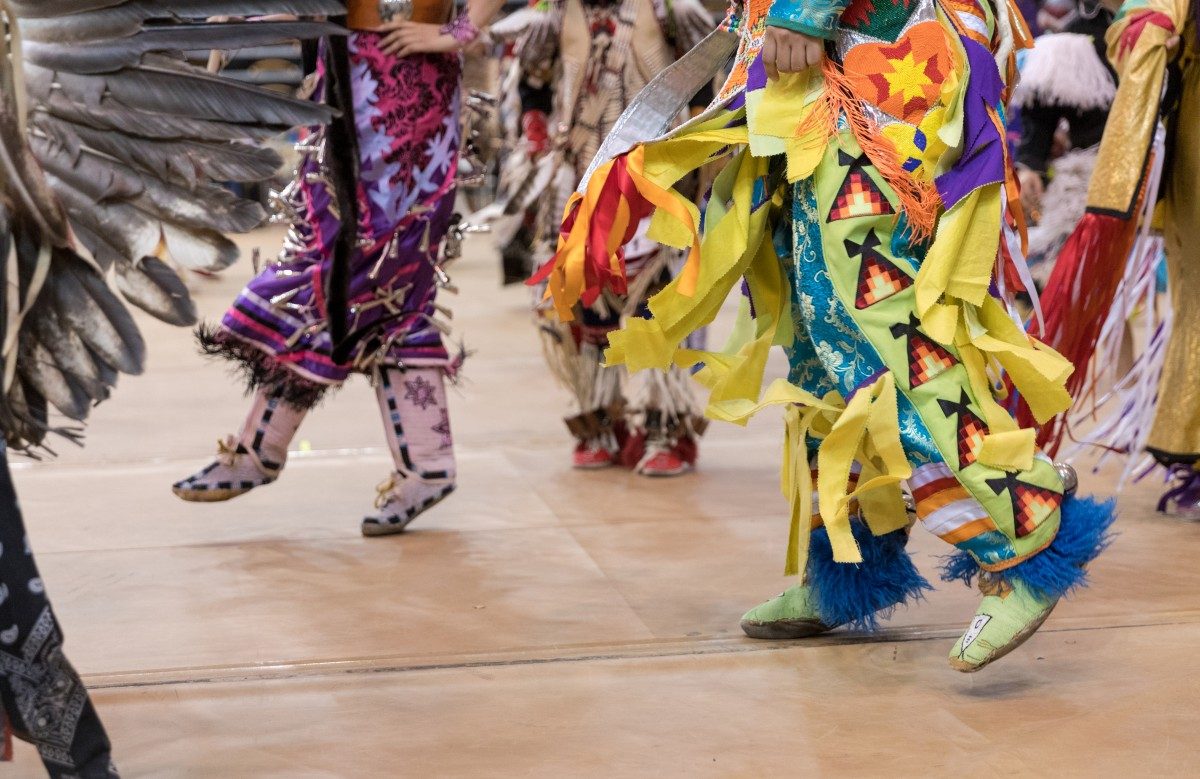 A photo of Pow Wow dancers' feet in regalia from the 2017 Traditional Graduation Pow Wow