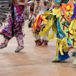 A photo of Pow Wow dancers' feet in regalia from the 2017 Traditional Graduation Pow Wow