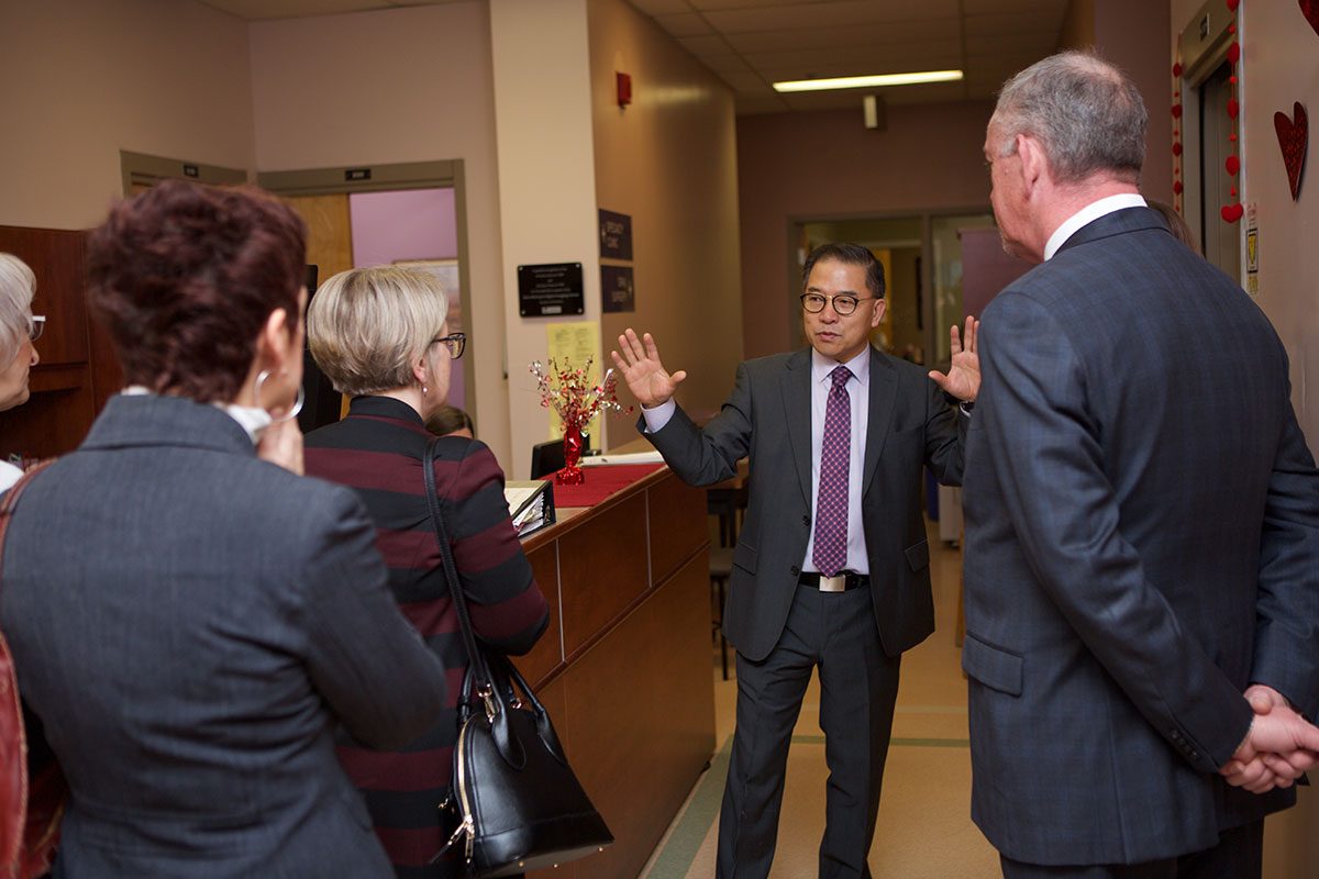 Dr. Aaron Kim, Associate Dean of Clinics, guides representatives from Scotiabank on a tour of the College of Dentistry's Patient Care Clinic on Jan. 15, 2018.