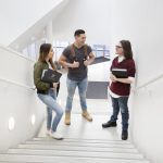 Three Indigenous students on the stairs of ARTlab
