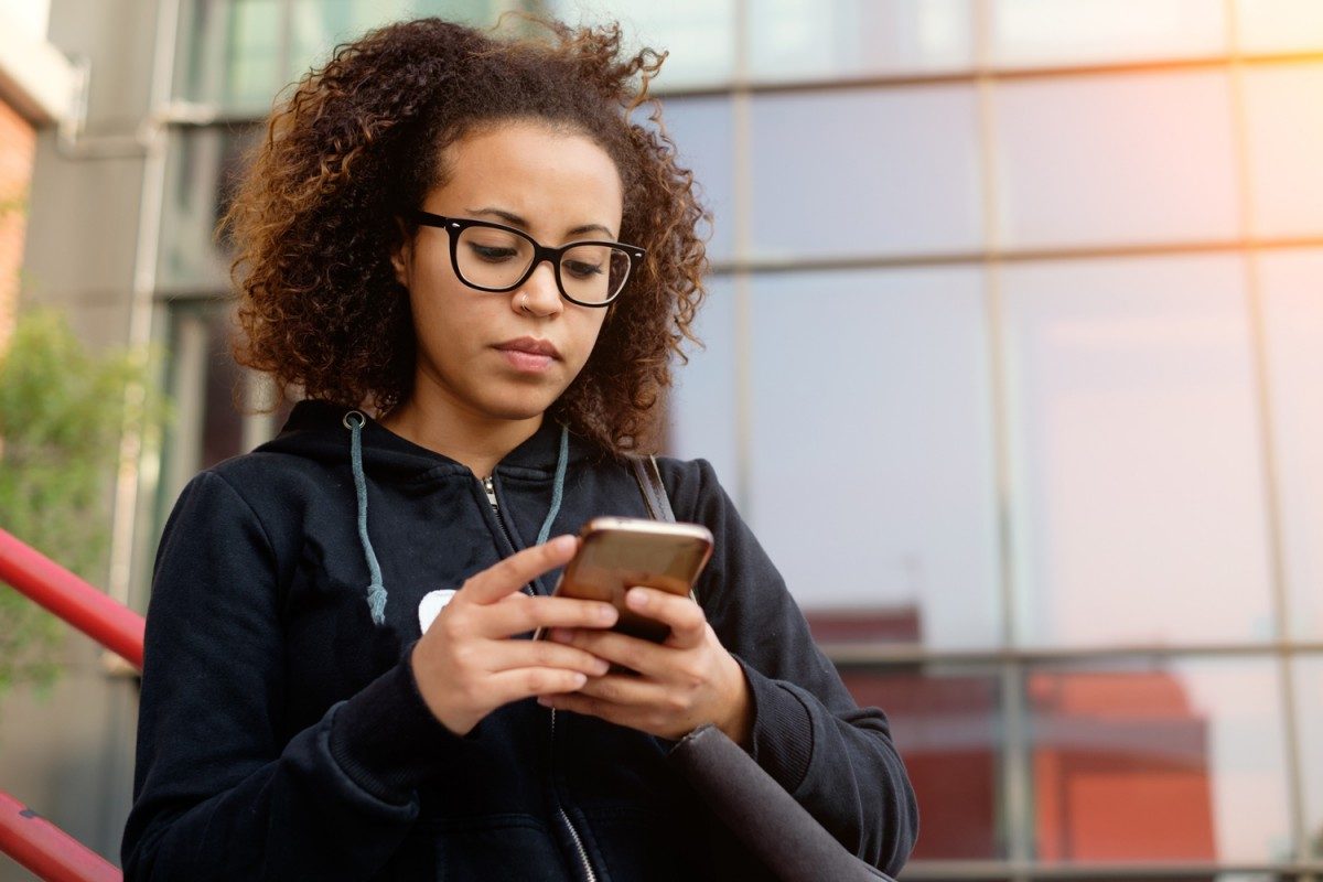 Young woman looking at her mobile phone