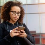 Young woman looking at her mobile phone