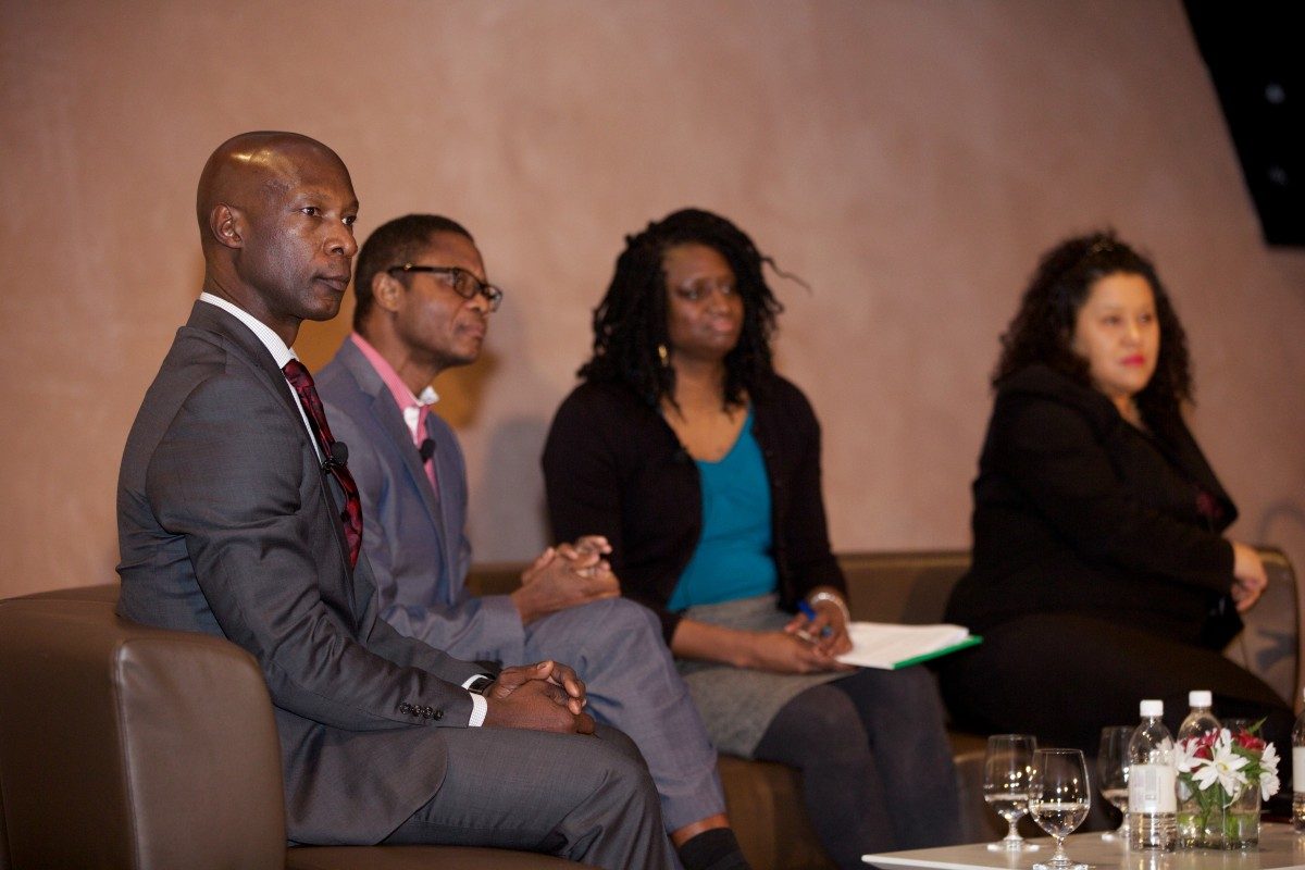 Panelists sitting on stage, looking engaged