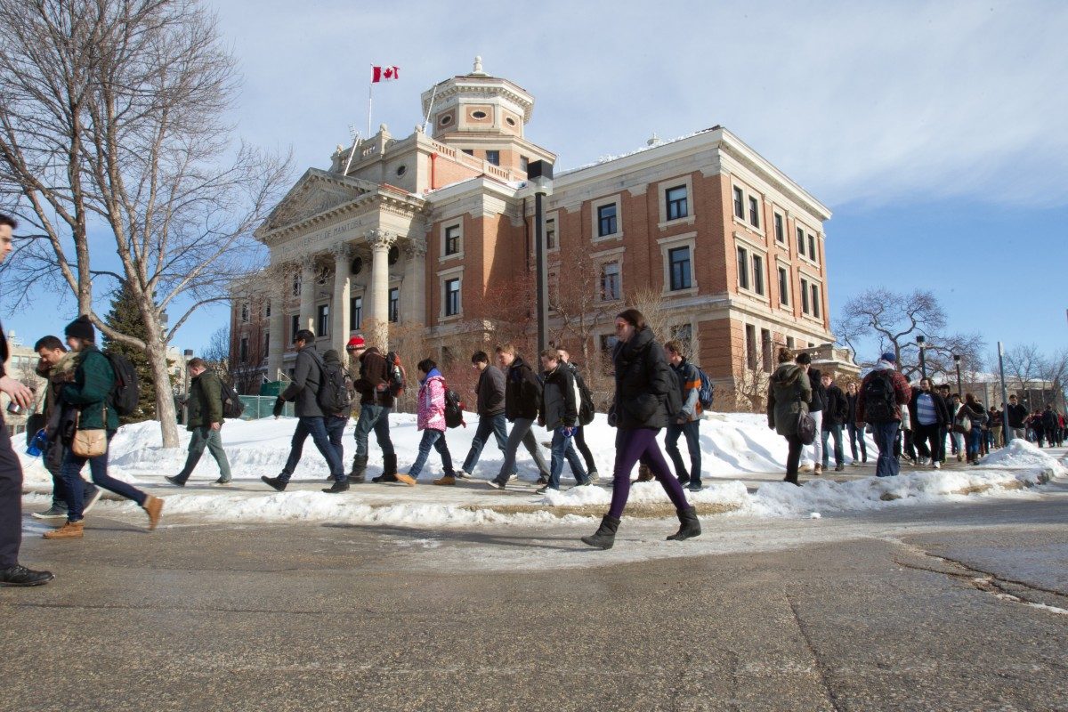 Students walk by the Administration Building