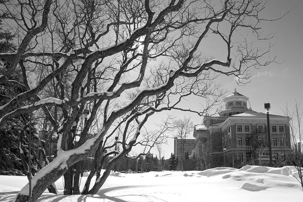 Admin building on campus in black and white photo.