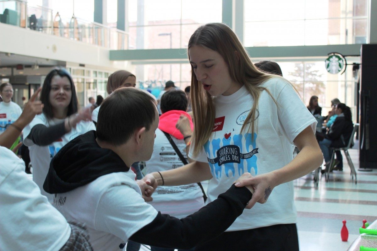 A student dances with a man