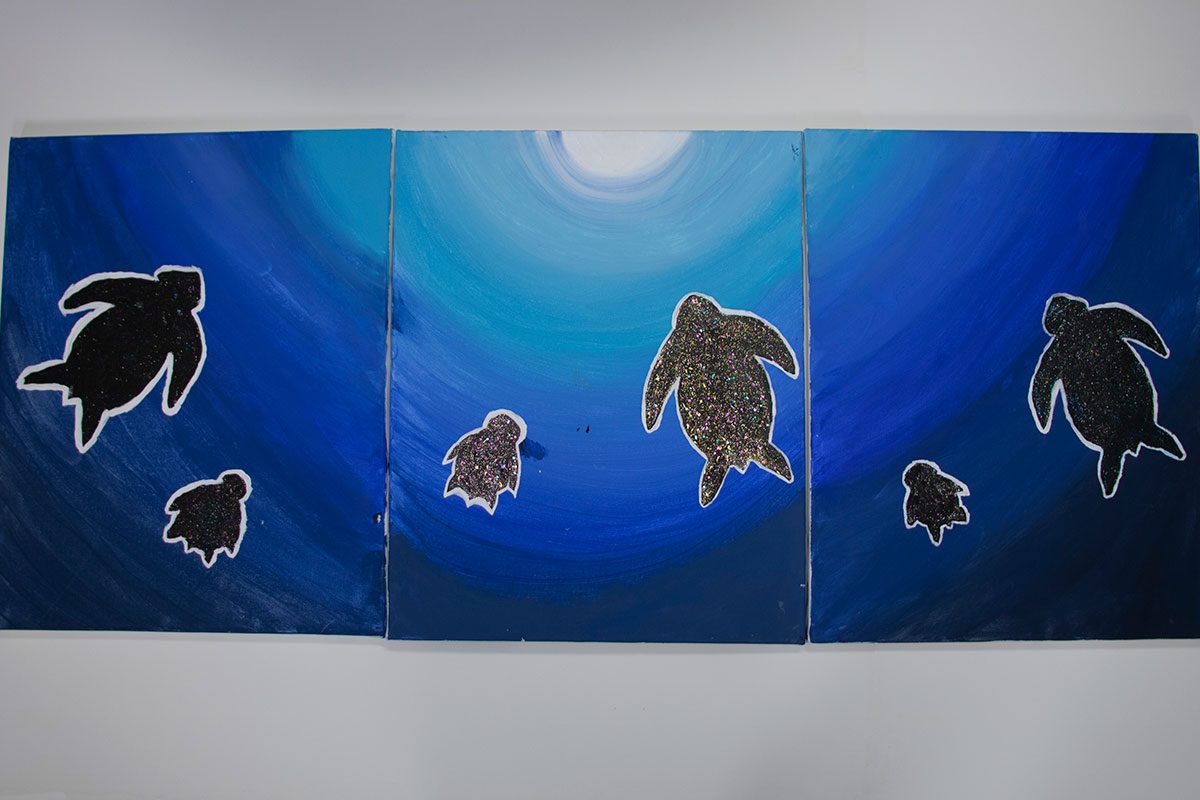 In this collaborative painting, the Manitoba artists chose the Turtle because it represents truth, which is necessary for a peaceful life. Catterie Wood, Jade Larocque, Journey Irvine .