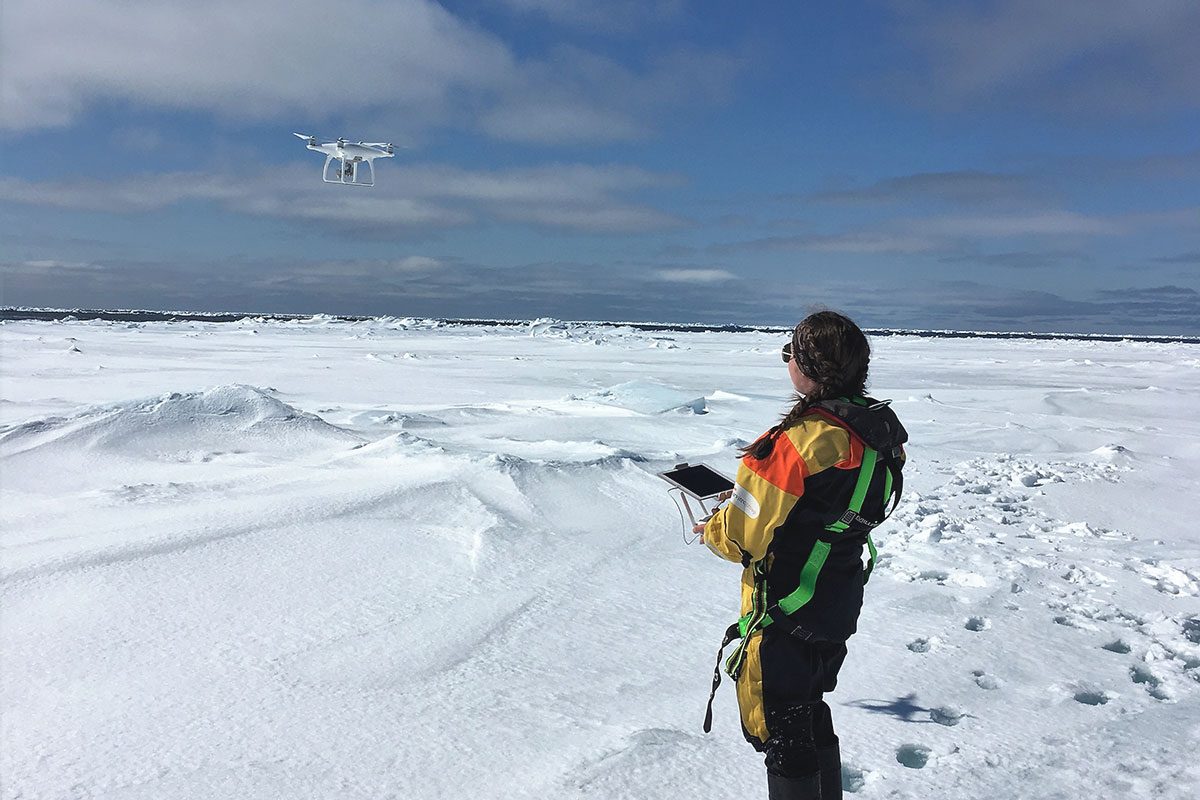 Madison Harasyn flying a drone over ice.