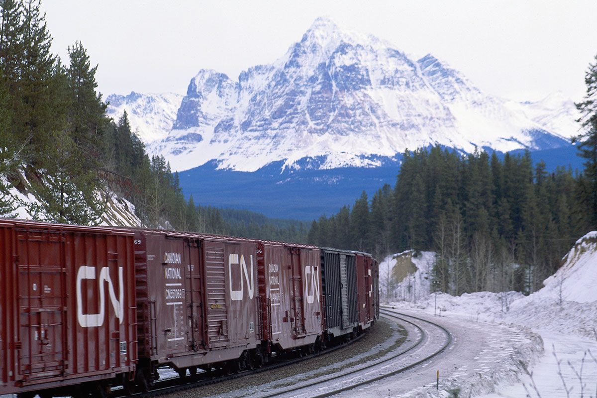 CNR train driving through Canadian Rockies. // Image from Canadian National Railway Company