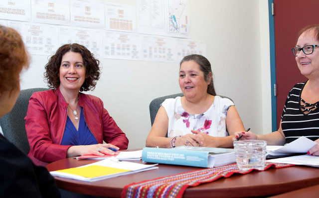 (L-R): Michelle Driedger, with research partners at Manitoba Metis Federation, Georgina Liberty and Sheila Carter (Julianne Sanguins, with back to camera).