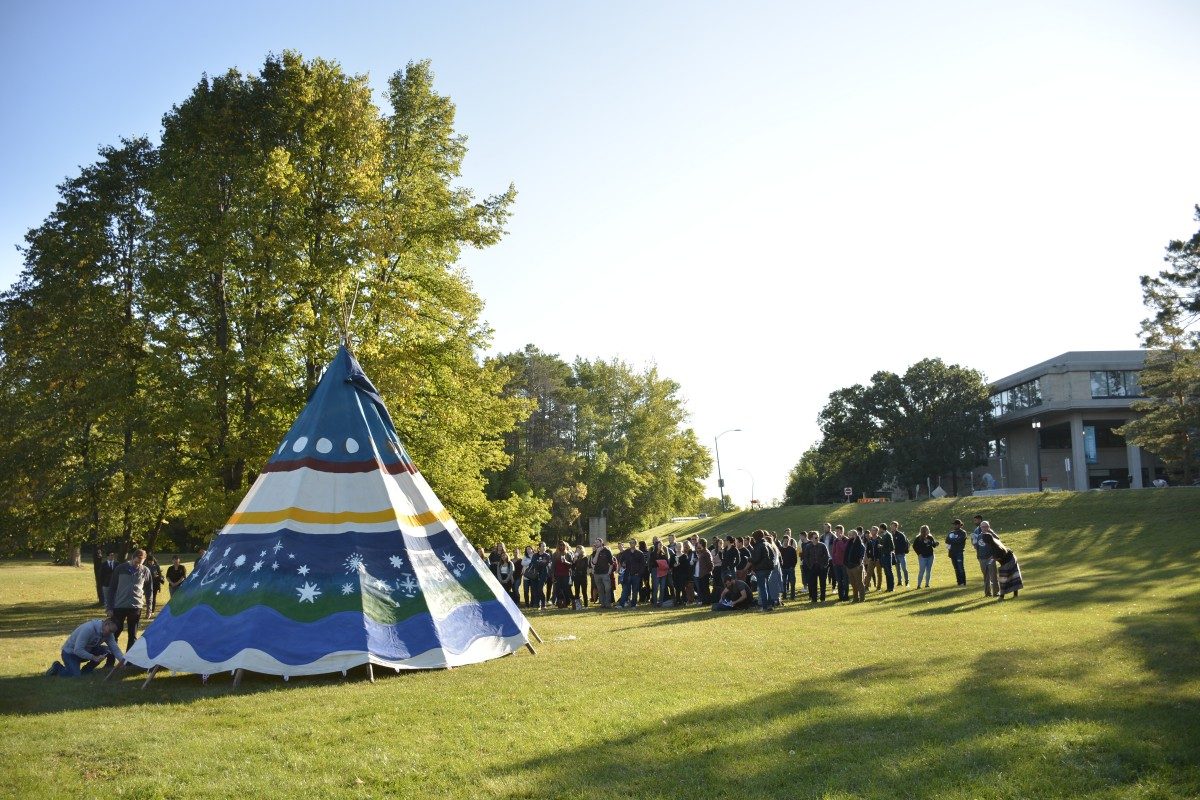 First Year Law Students help erect a tipi in view of Robson Hall as they learn about Indigenous traditions during Orientation Week.