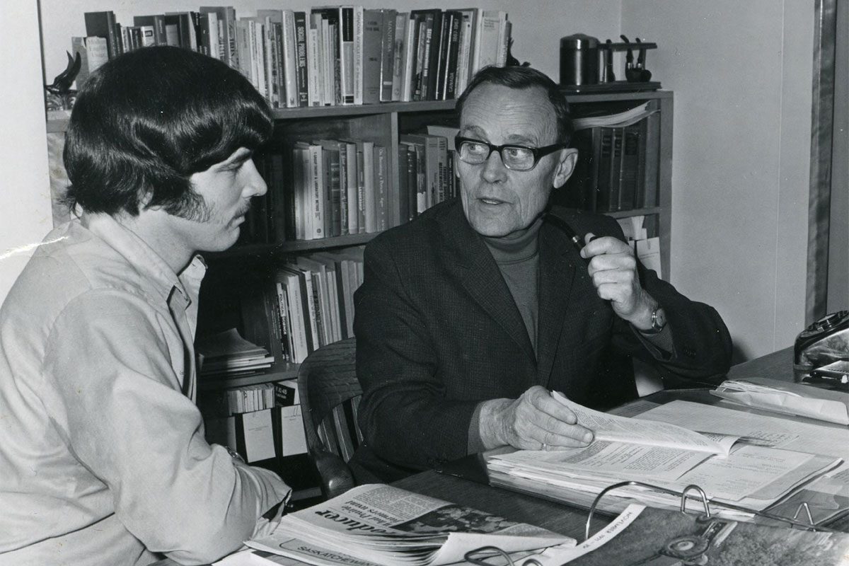 A photo of agriculture student John Enns with Eugene Lange in Lange's office.
