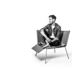 Thom Fougere sits in a chair of his own design.