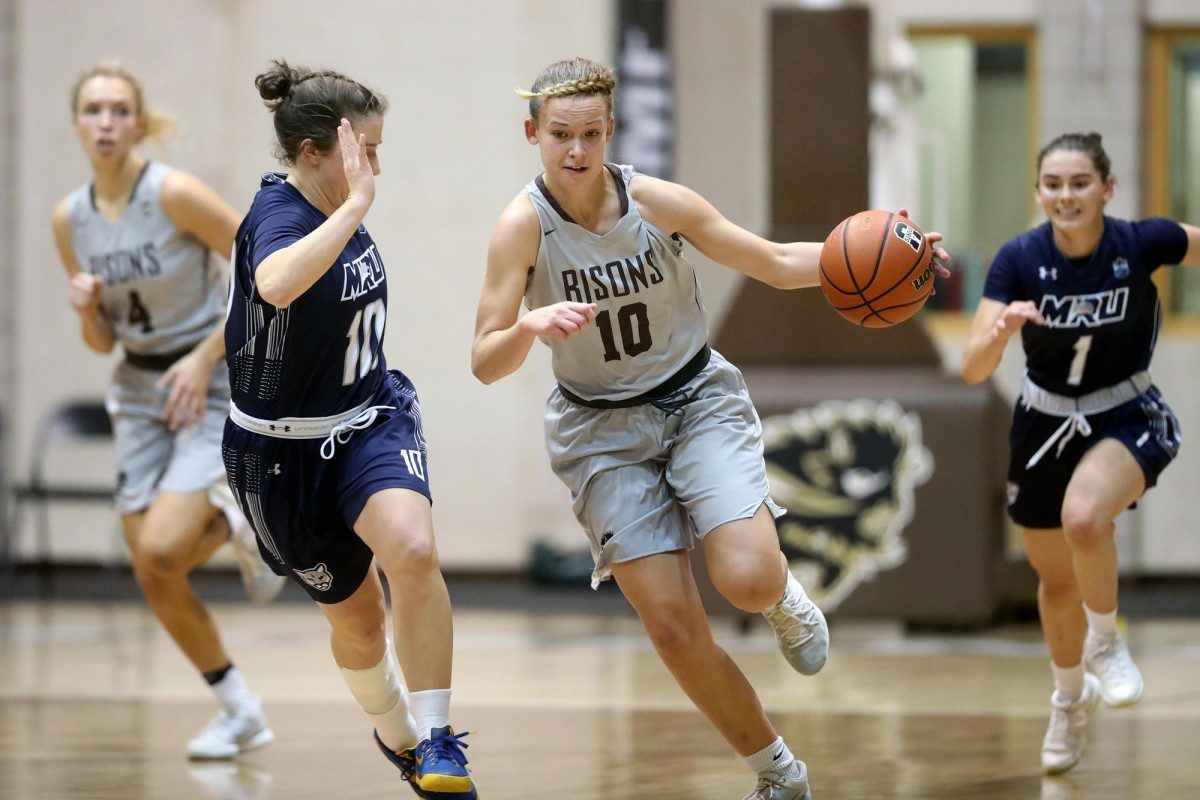 Bison Nicole Konieczny drives against Mount Royal