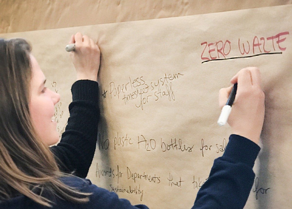 Student writing a comment during a public engagement event