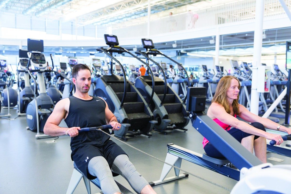 Two people exercising in a gym