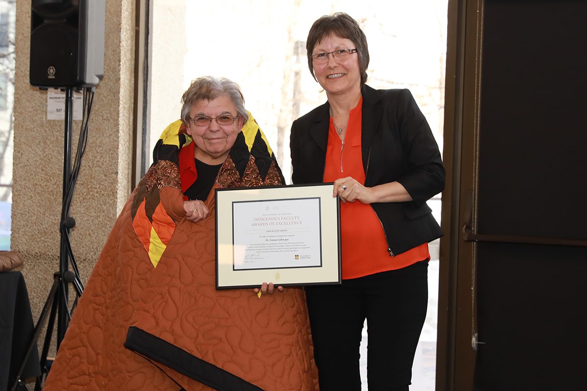 Dr. Emma LaRoque receives Indigenous Award of Excellence from Adrienne Carriere.