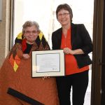 Dr. Emma LaRoque receives Indigenous Award of Excellence from Adrienne Carriere.