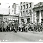 Special police marching west down Portage from Main Street during June 10, 2019 riot. // Winnipeg Tribune Photograph Collection at U of M Archives and Special Collections